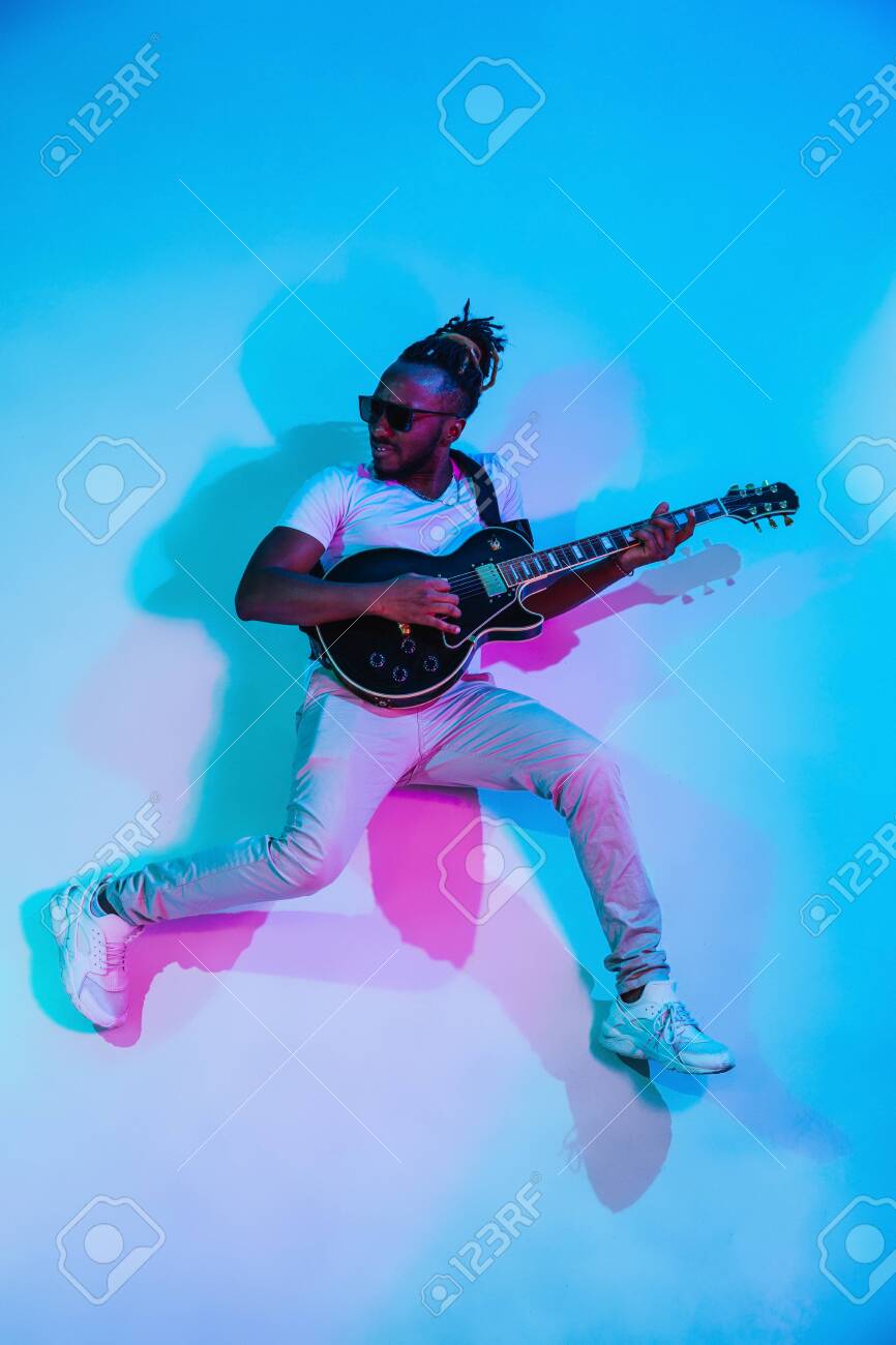 Young African American Musician Playing The Guitar Like A Rockstar