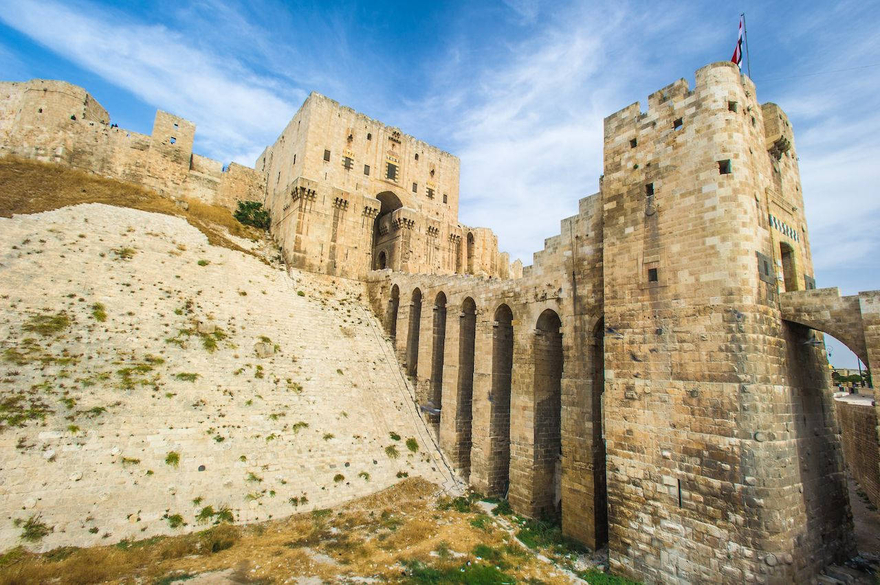 A majestic view of the Krak des Chevaliers, a Crusader castle in Syria, showcasing its impressive fortifications and strategic location