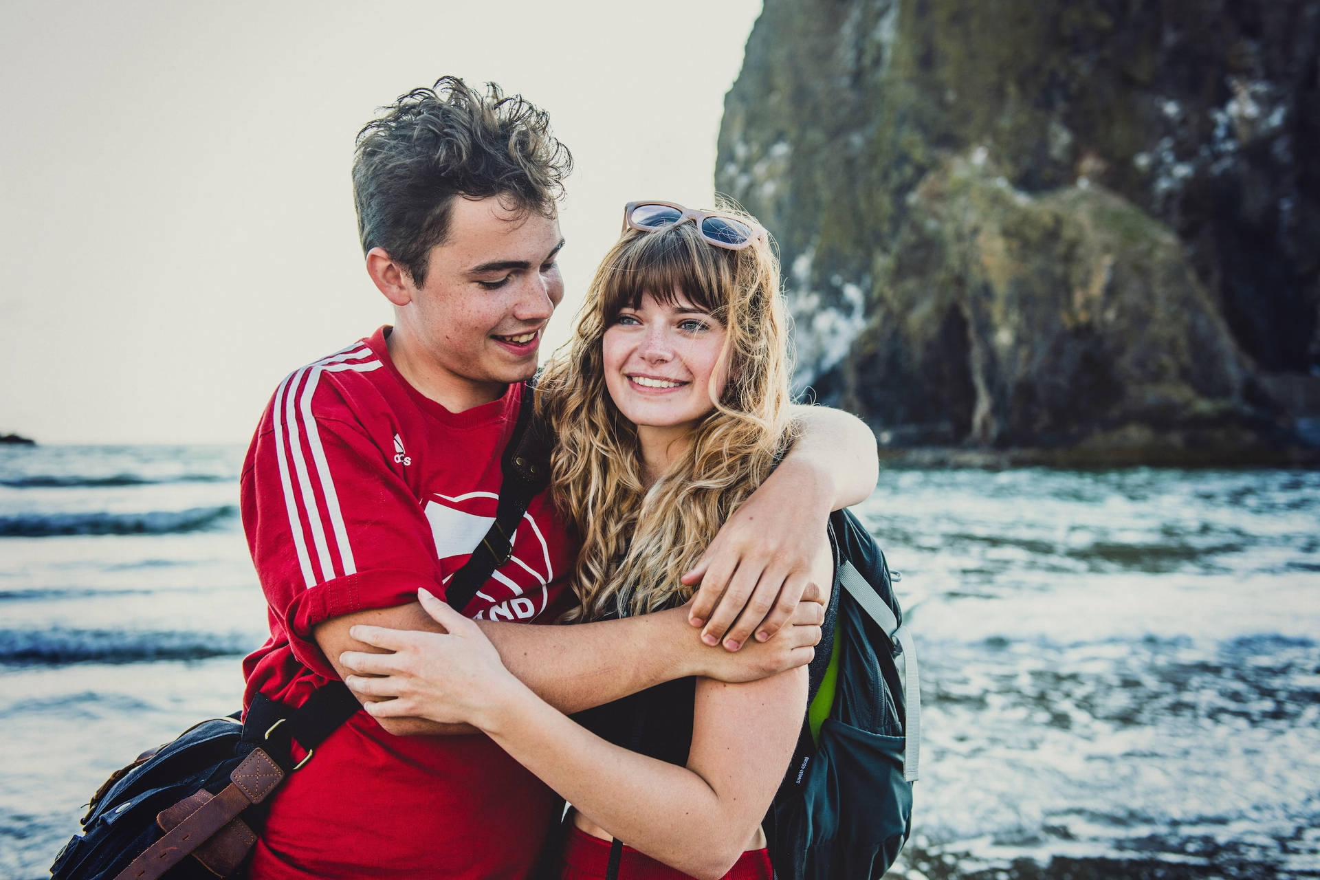 Couple Hugging Side By On The Beach Wallpaper