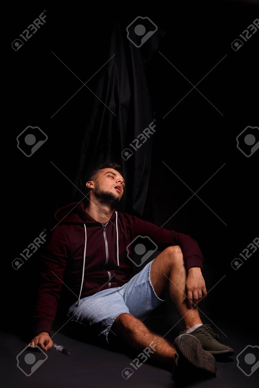 Weak Sick Guy With Overdose Death Upon A Male Sitting On