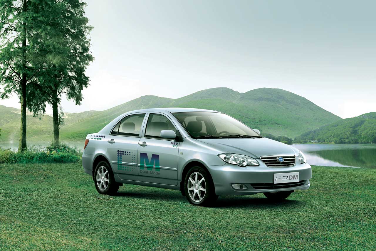 BYD F3DM Plug-in Hybrid Sedan parked in a serene natural landscape