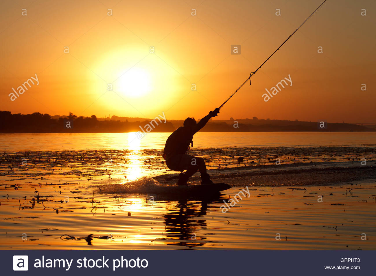 A Wakeboard Athlete Silhouette On Sunset Background Stock Photo