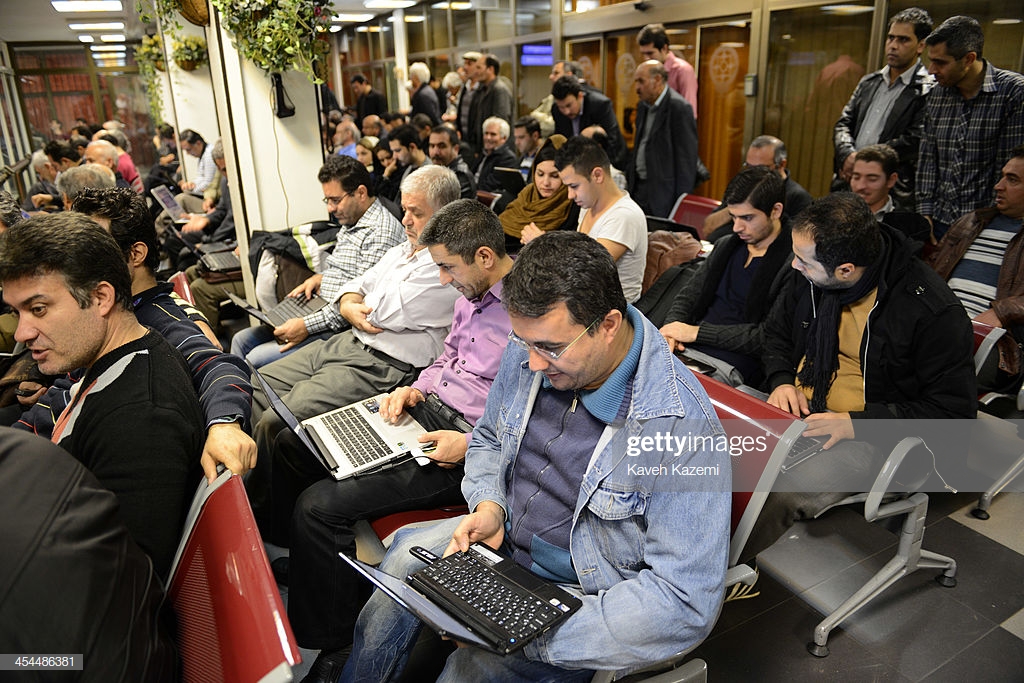 People Busy With Their Laptops Following The Markets Trends At