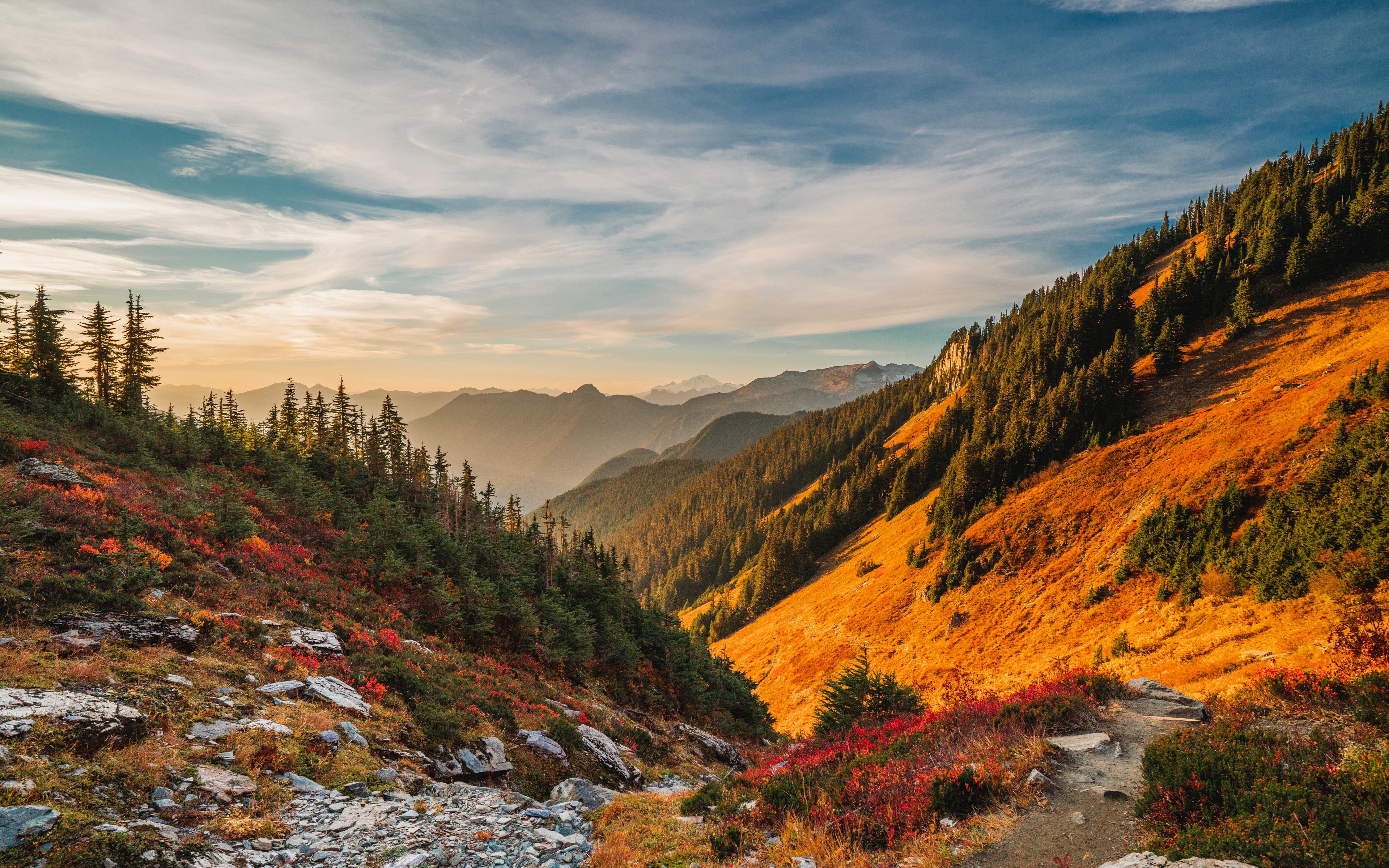Scenic 4k wallpaper of a vibrant autumn mountain landscape with a winding hiking trail
