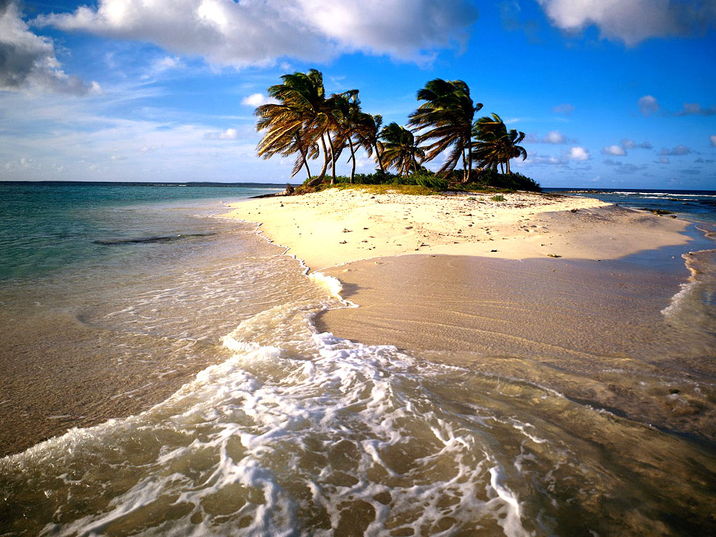 A small, secluded island paradise with palm trees swaying in the breeze, surrounded by crystal-clear turquoise water and white sandy beach