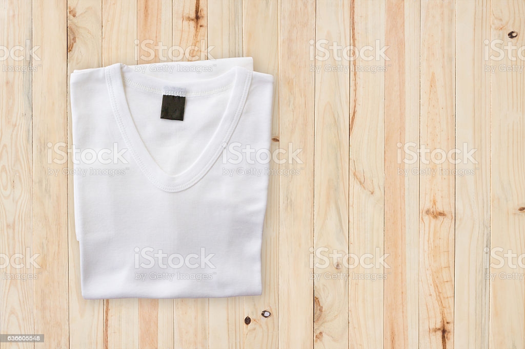 Top Of White Tshirt On Wood Table Background Stock Photo