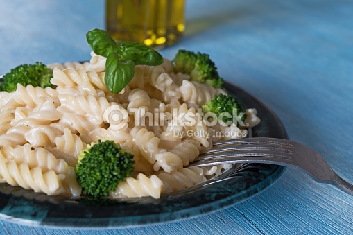 Pasta On Plate Blue Wooden Background Stock Photo Thinkstock