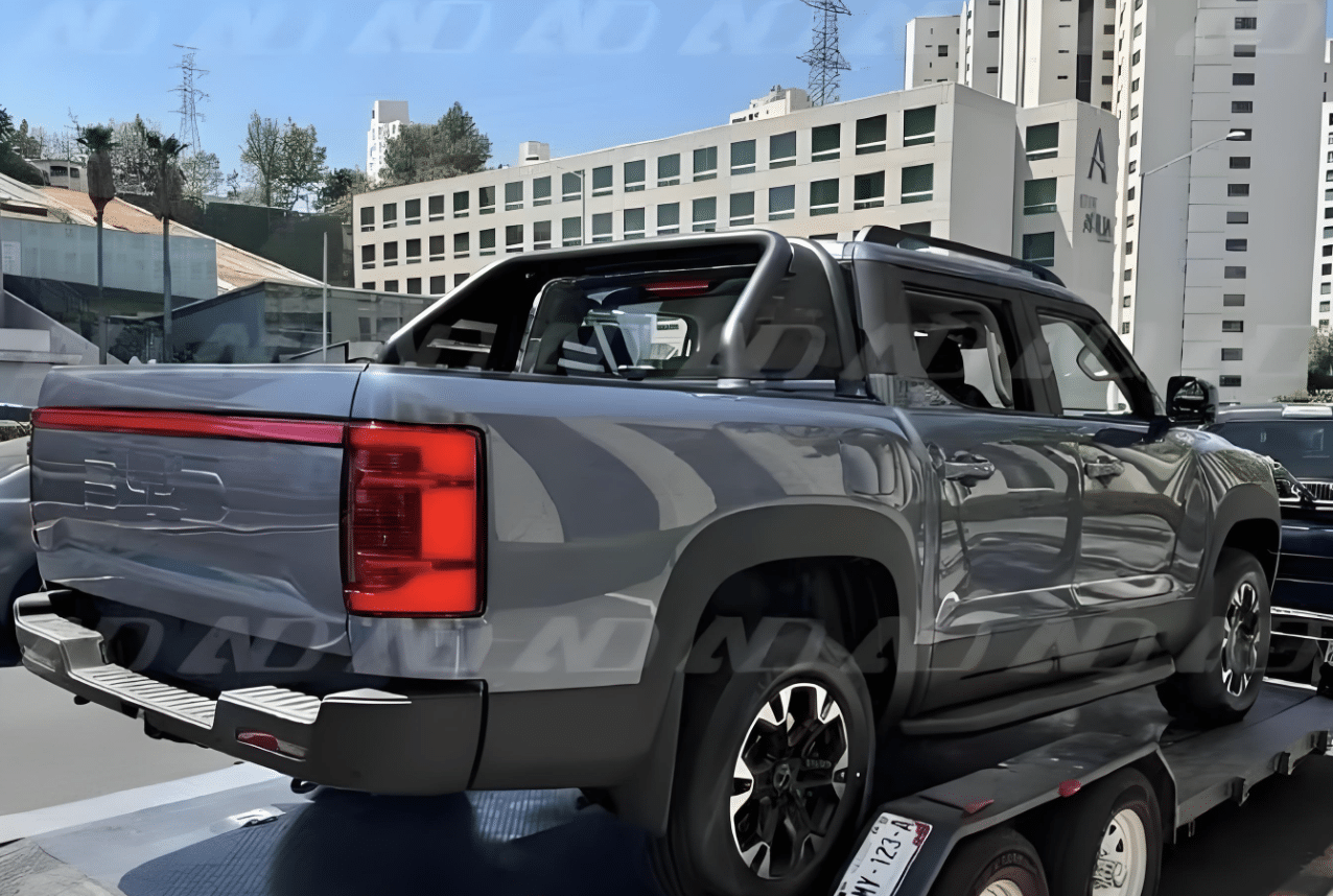 A BYD Shark pickup truck being transported on a trailer