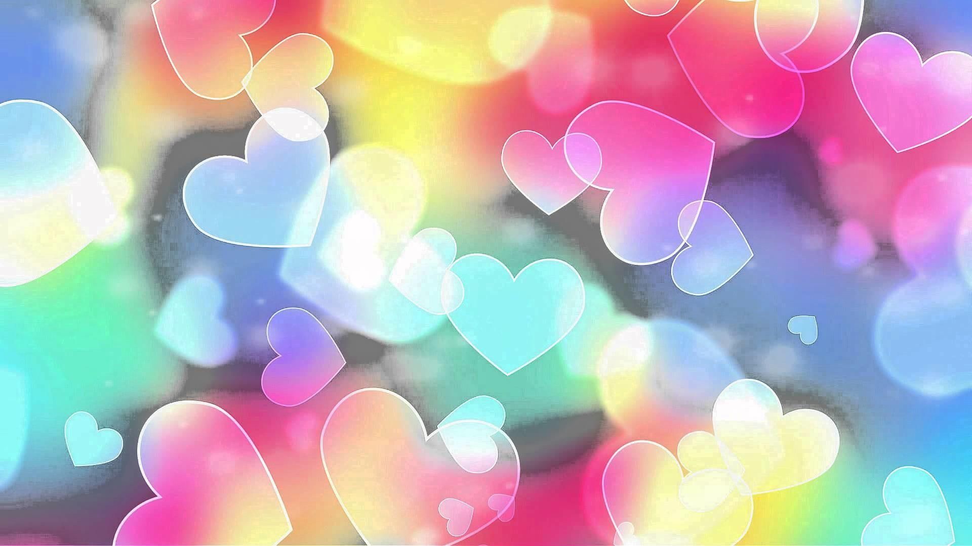 Colorful Heart Bokeh Background: A vibrant and dreamy wallpaper filled with translucent, pastel-colored hearts floating on a soft, multi-hued backdrop