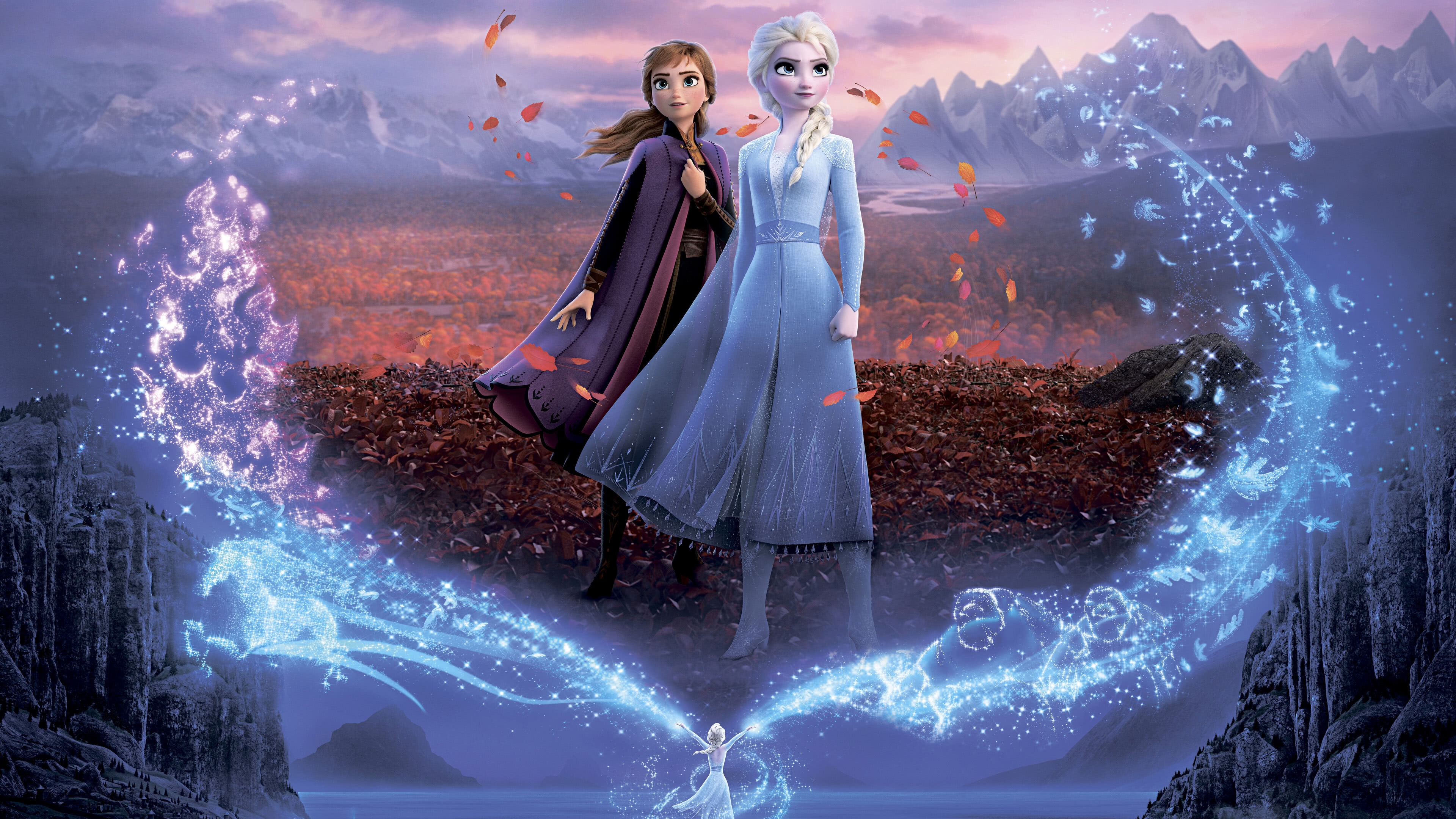 Anna and Elsa stand together amidst swirling autumn leaves and icy magic in a promotional image for Frozen 2