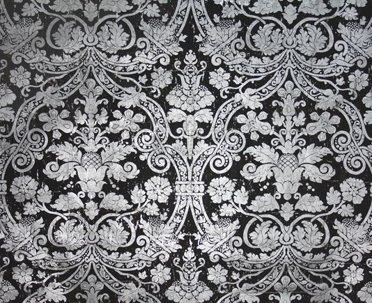Distressed Wide Width Wallpaper With A Metallic Silver Damask Print