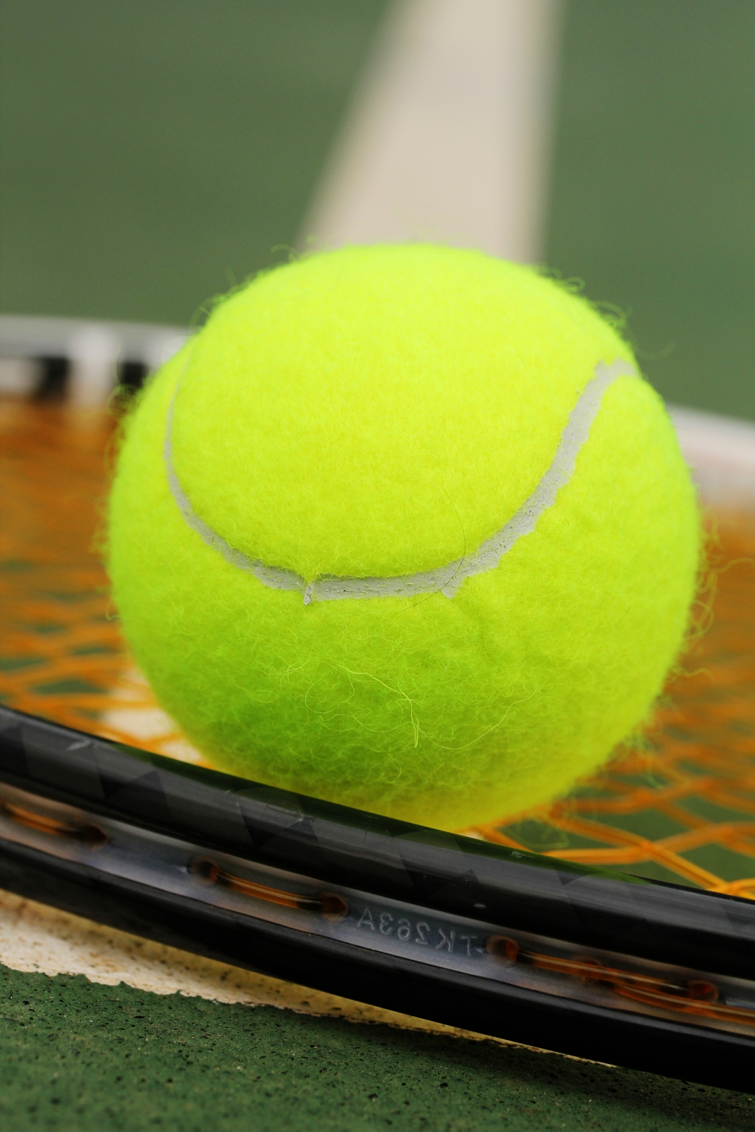 Tennis Balls And Racket On Synthetic Court Surface