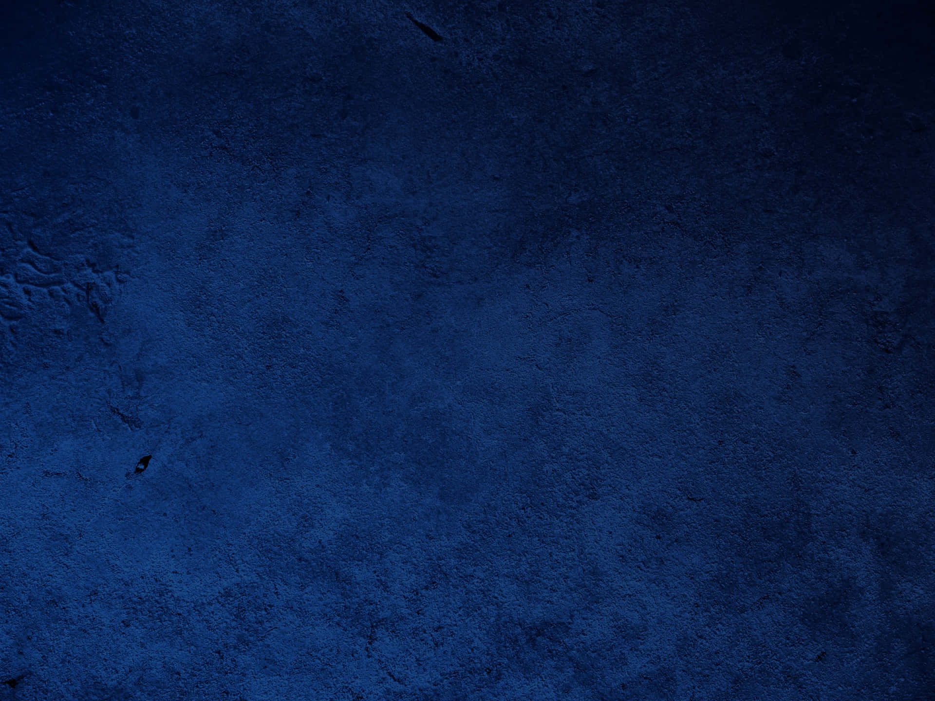 Dark navy blue textured background with a subtle grunge effect, perfect for wallpapers or graphic design projects