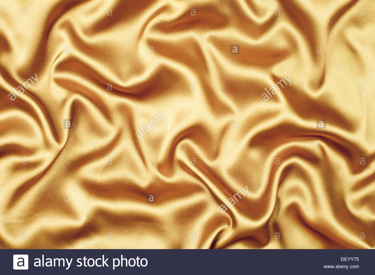 Gold Satin Or Silk Fabric Background Stock Photo