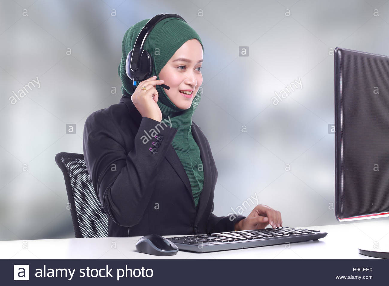 Young Muslim Women Helpline Operator Talking On Blur Background