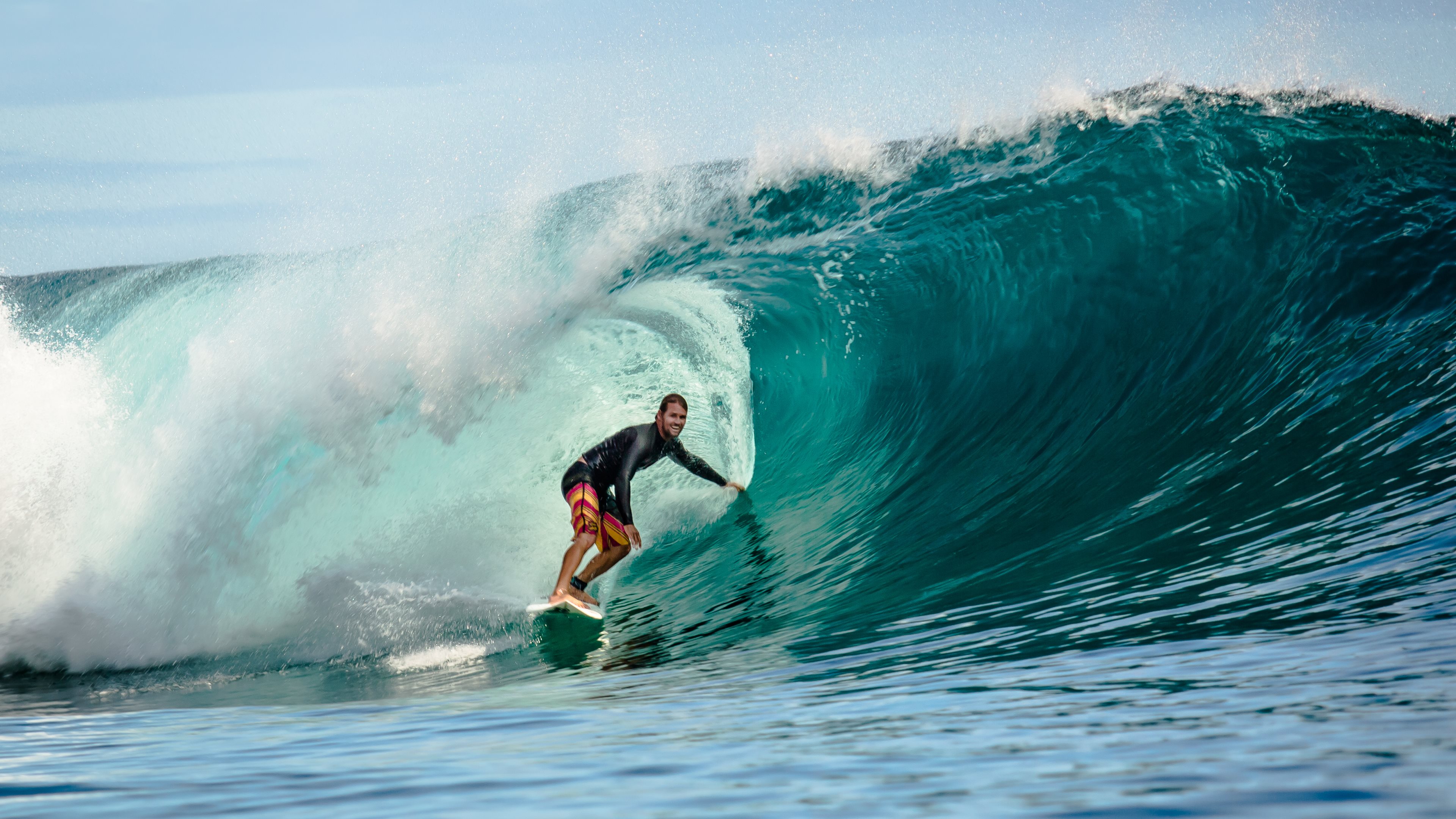 A surfer riding a powerful wave in the ocean
