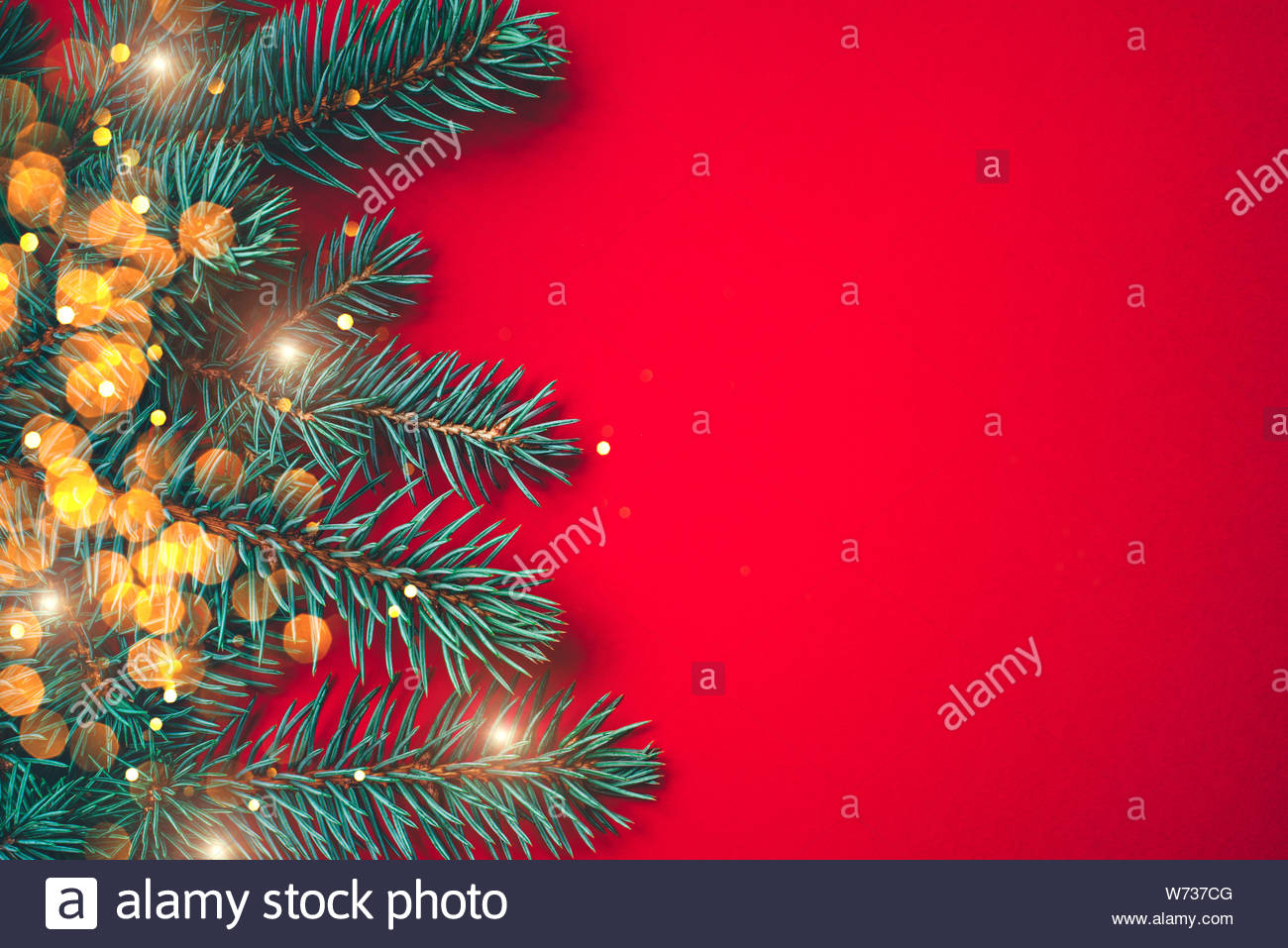 Fir Branches With Blurred Lights Garland On A Red Background