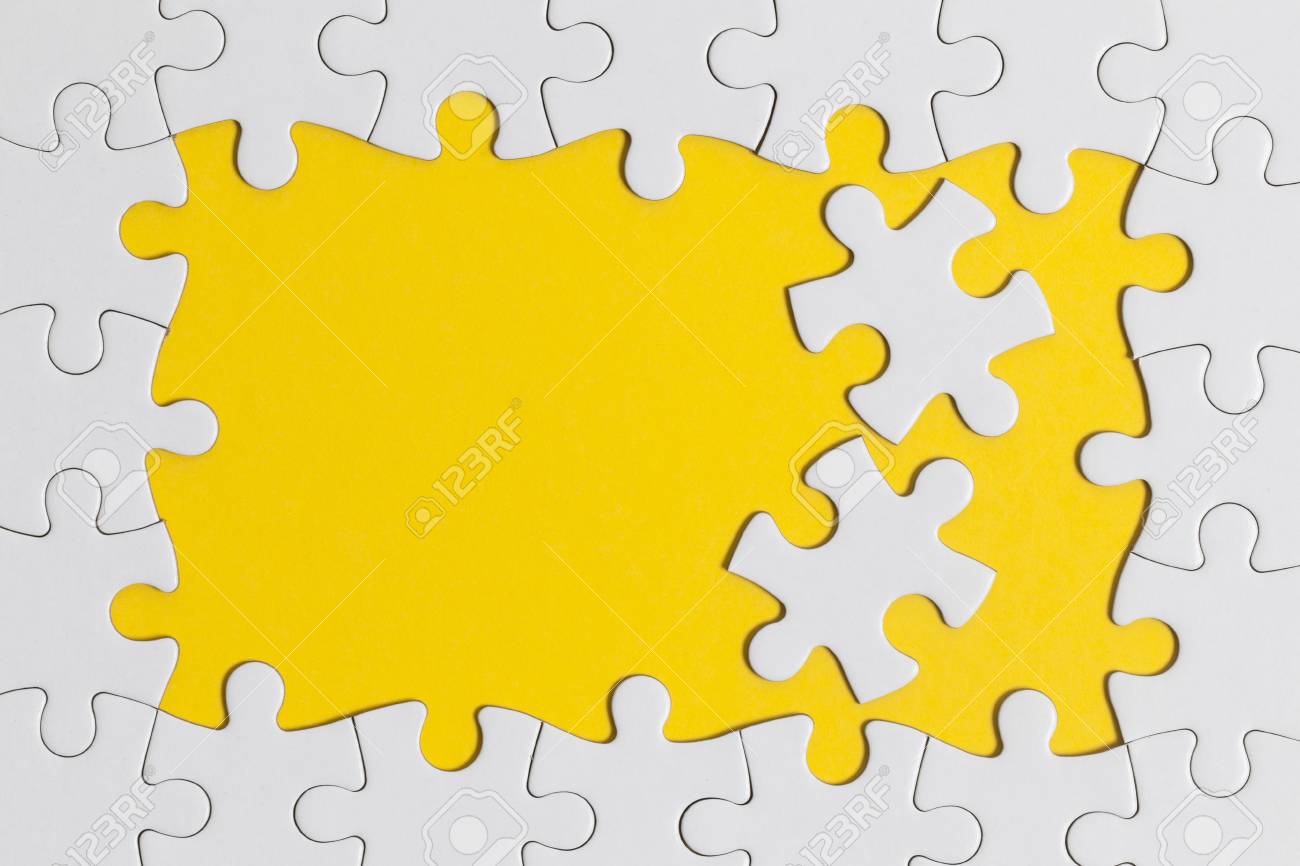 White Jigsaw Puzzle Pieces On A Yellow Background Business