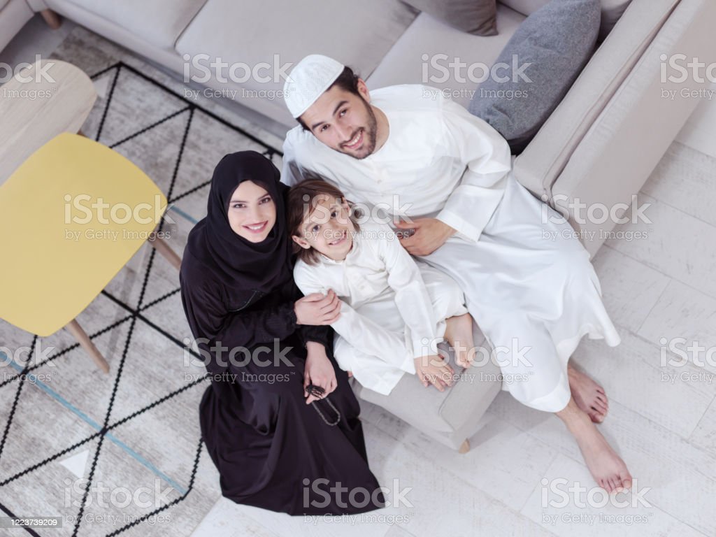 Muslim Family Reading Quran And Praying At Home Stock Photo