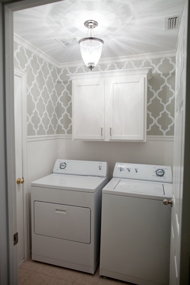 Grey stenciled laundry room with wallpaper wainscoting The after