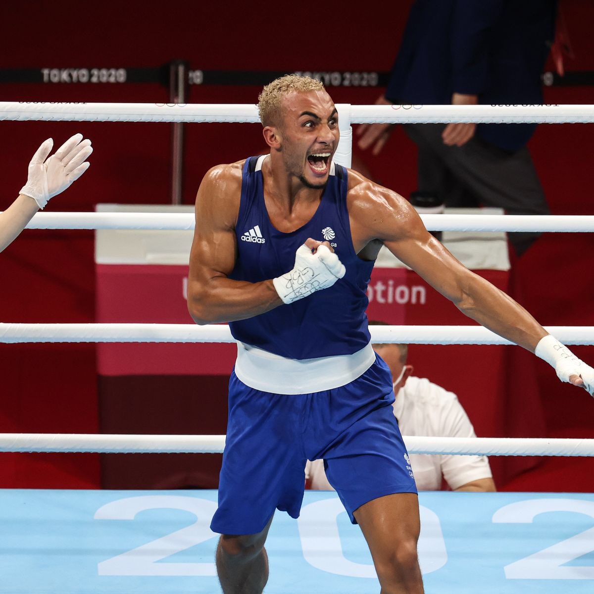Benjamin Whittaker celebrates victory in a boxing match at the Olympics