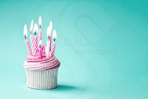 Pink BirtHDay Cupcake Against A Blue Background Royalty Stock