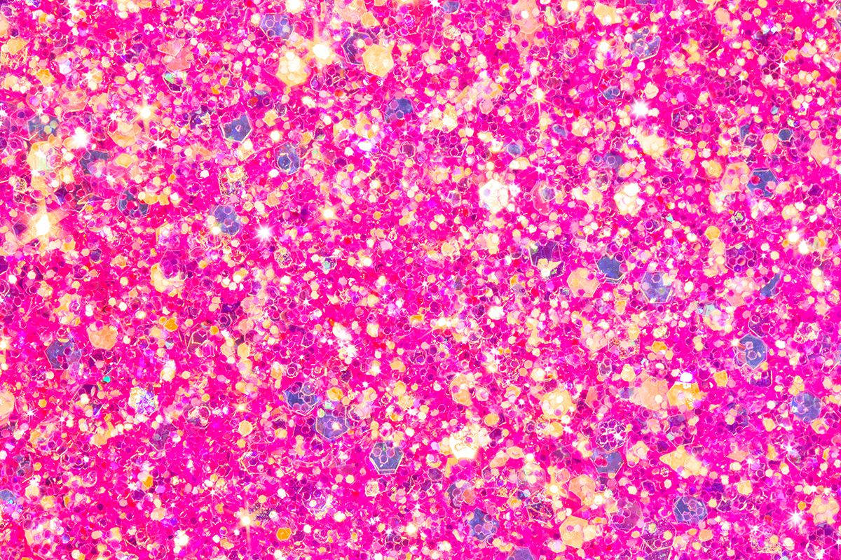 A close-up view of vibrant pink glitter, sparkling and shimmering with iridescent highlights