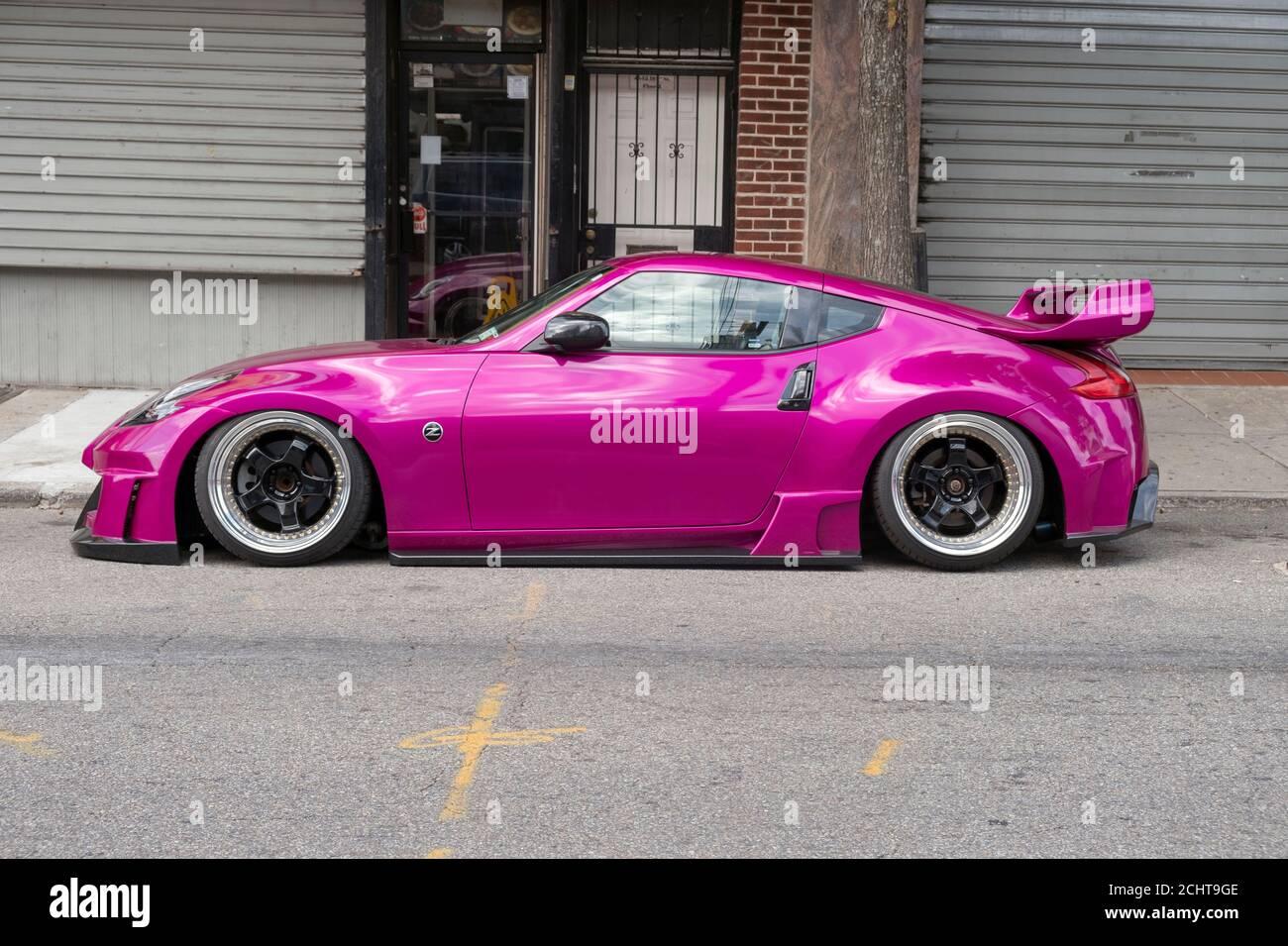 A Customized Magenta Nissan Modified By The Japanese Pany