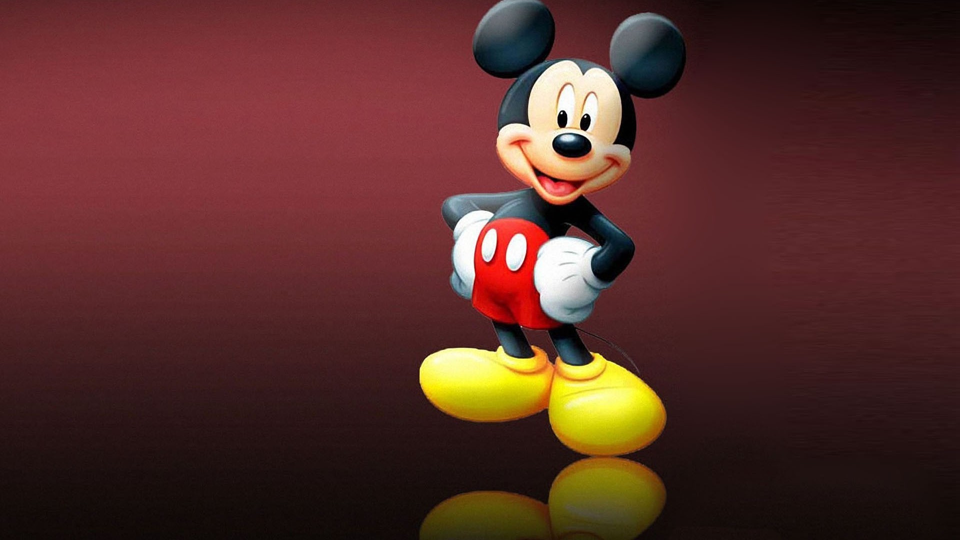 A cheerful Mickey Mouse with a big smile, standing against a gradient dark red background. His signature red shorts and yellow shoes are highlighted