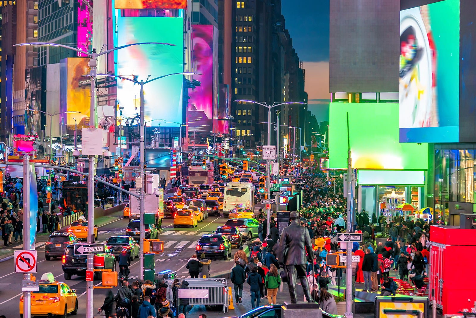 A vibrant night scene of Times Square on Broadway, showcasing the dazzling billboards, bustling traffic, and crowds of people