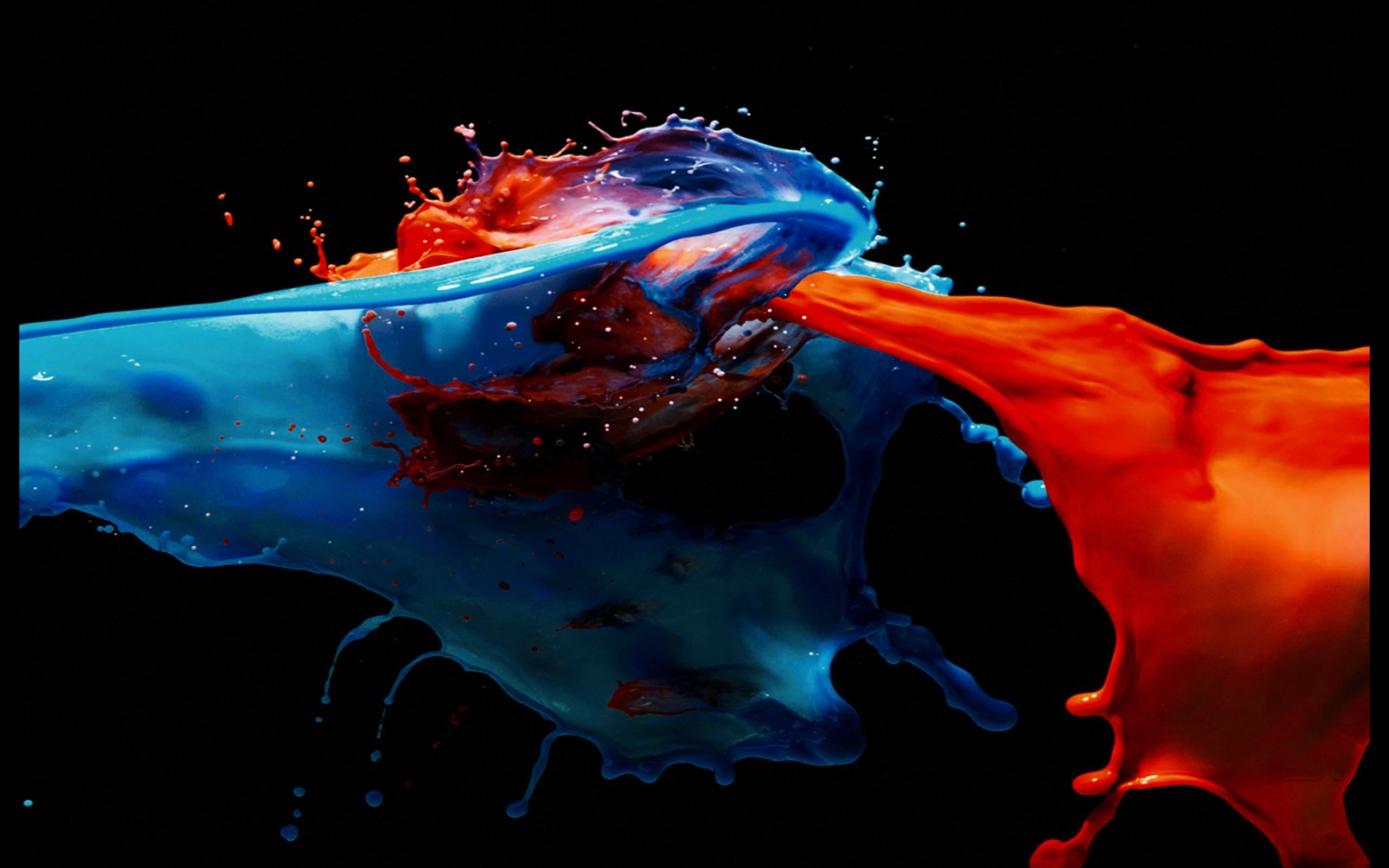 Dynamic splash of blue and red paint on a black background