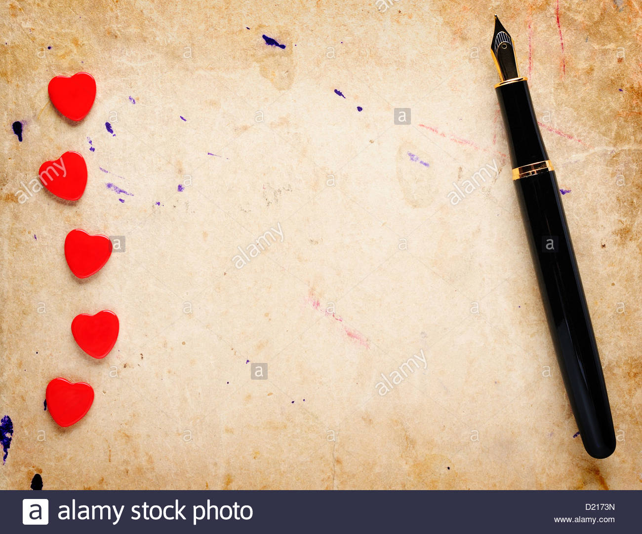 Red Hearts And Fountain Pen On Old Paper Background Stock Photo