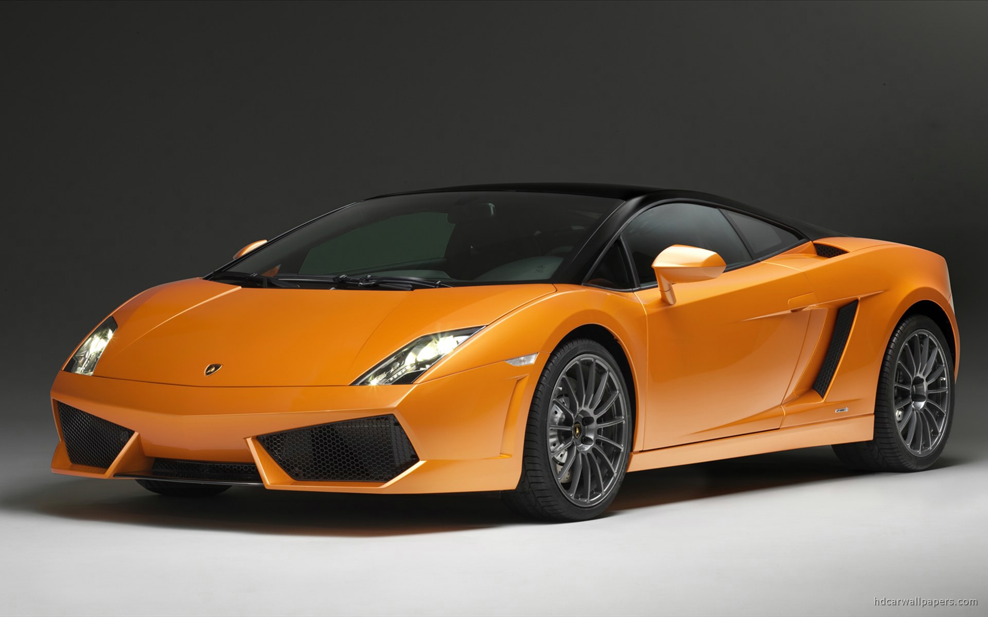 Orange Lamborghini Gallardo on a gray background