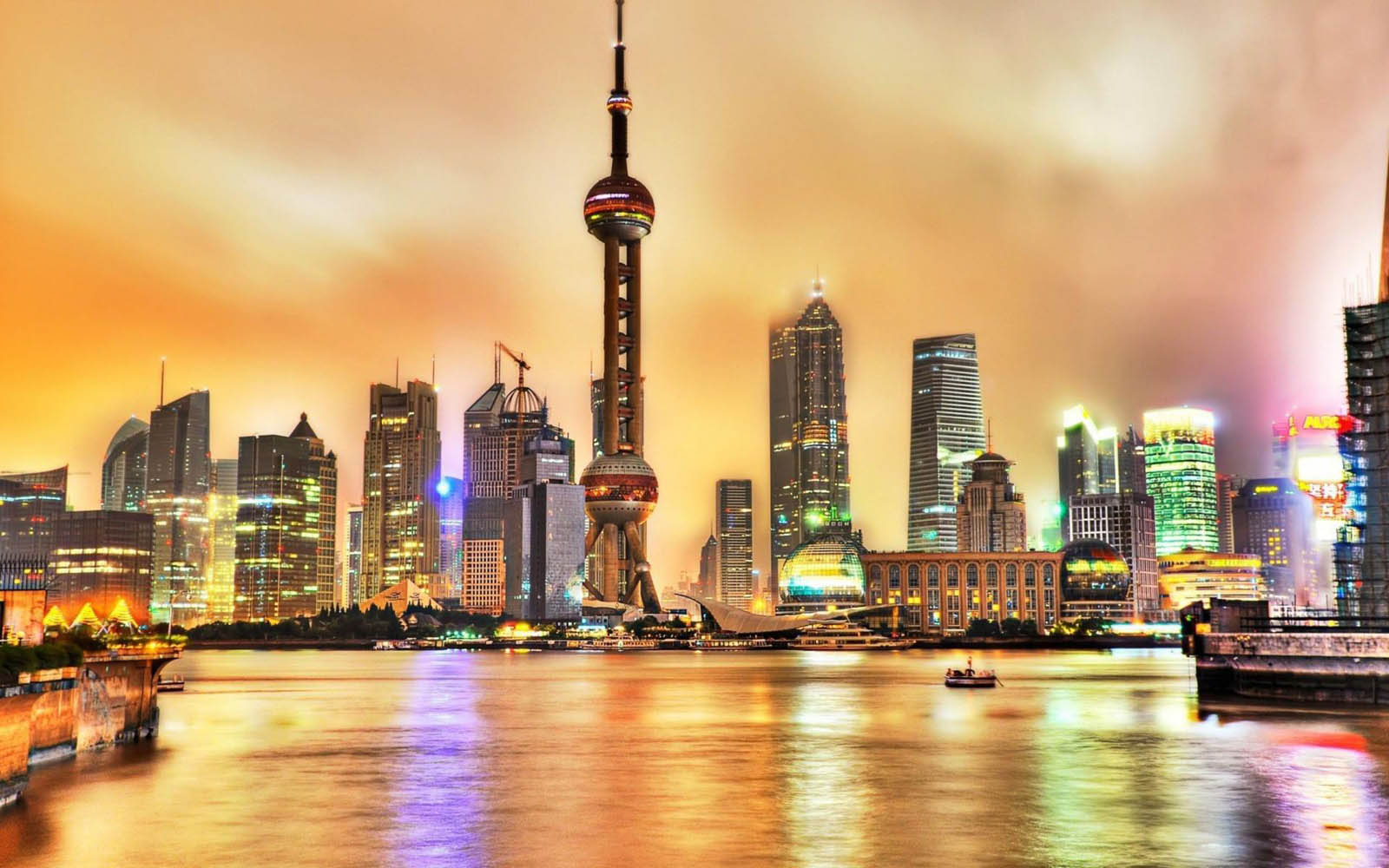 Vibrant cityscape of Shanghai at sunset with the Oriental Pearl Tower prominently featured in the skyline