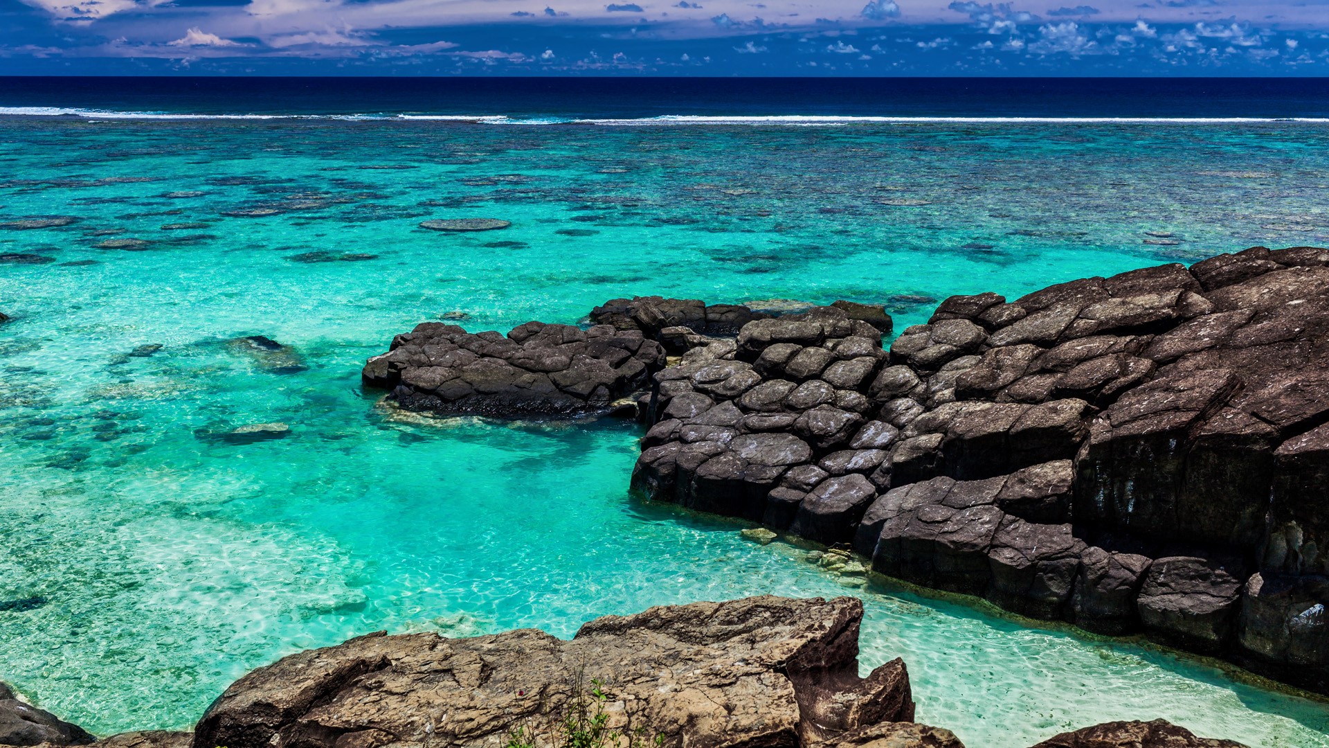 Tropical Beach Surrounded By Black Rocks Rarotonga Cook Islands
