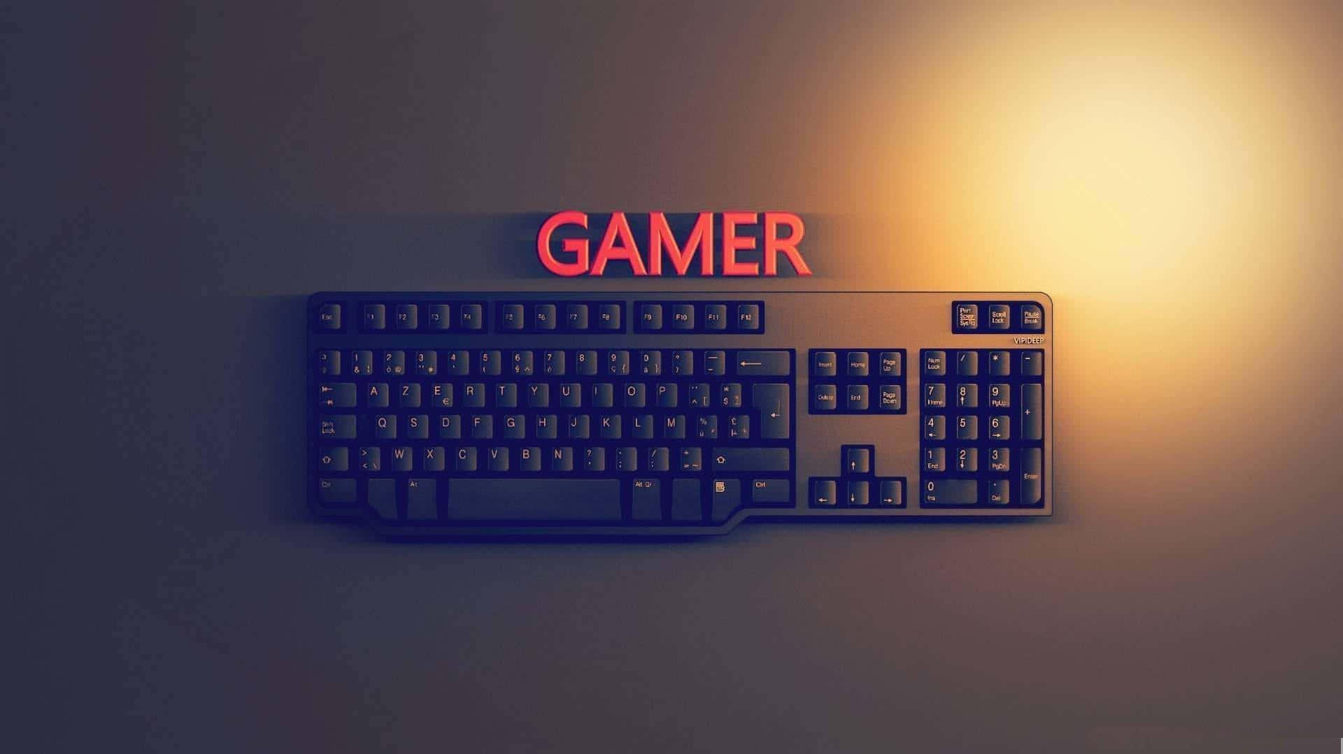 A Puter Keyboard With The Word Gamer On It Wallpaper