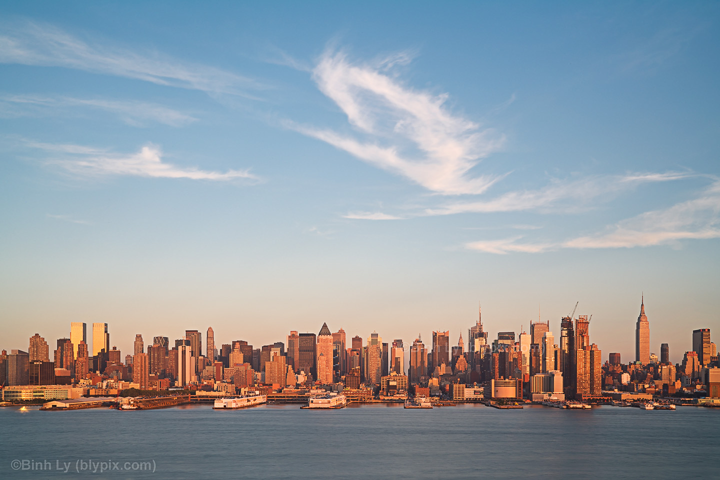 Warm Orange Sunset Light Shines On Midtown New York City Skyline The