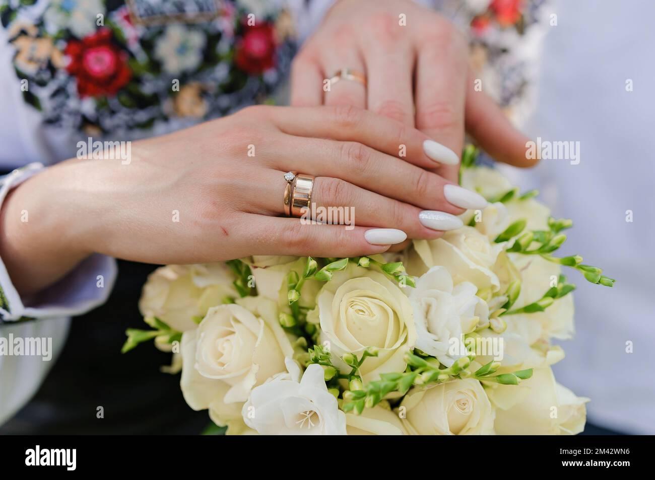 Golden Wedding Rings On The Hands Of Newlyweds Man And Woman