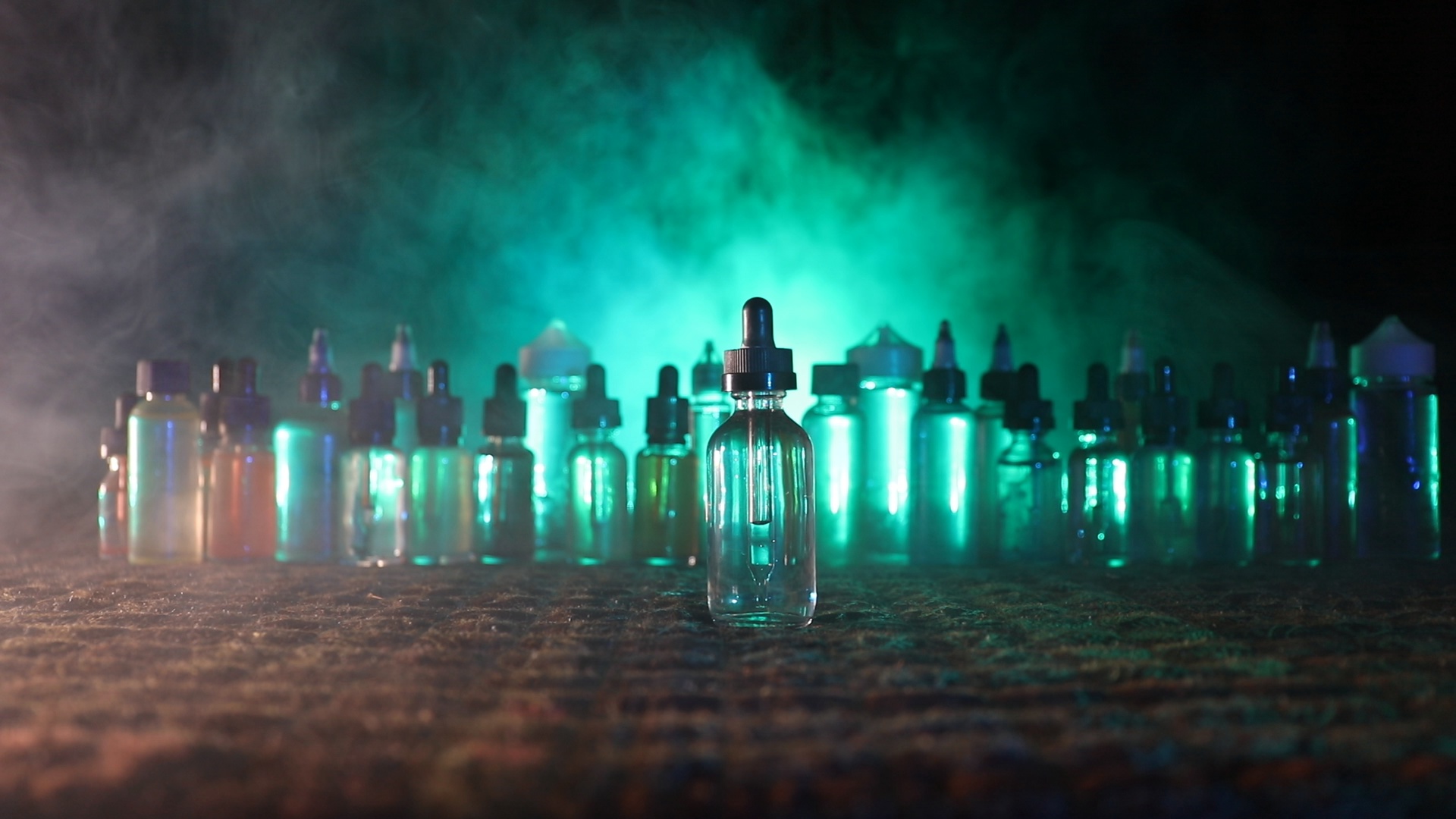 Vape Concept Smoke Clouds And Liquid Bottles At Dark
