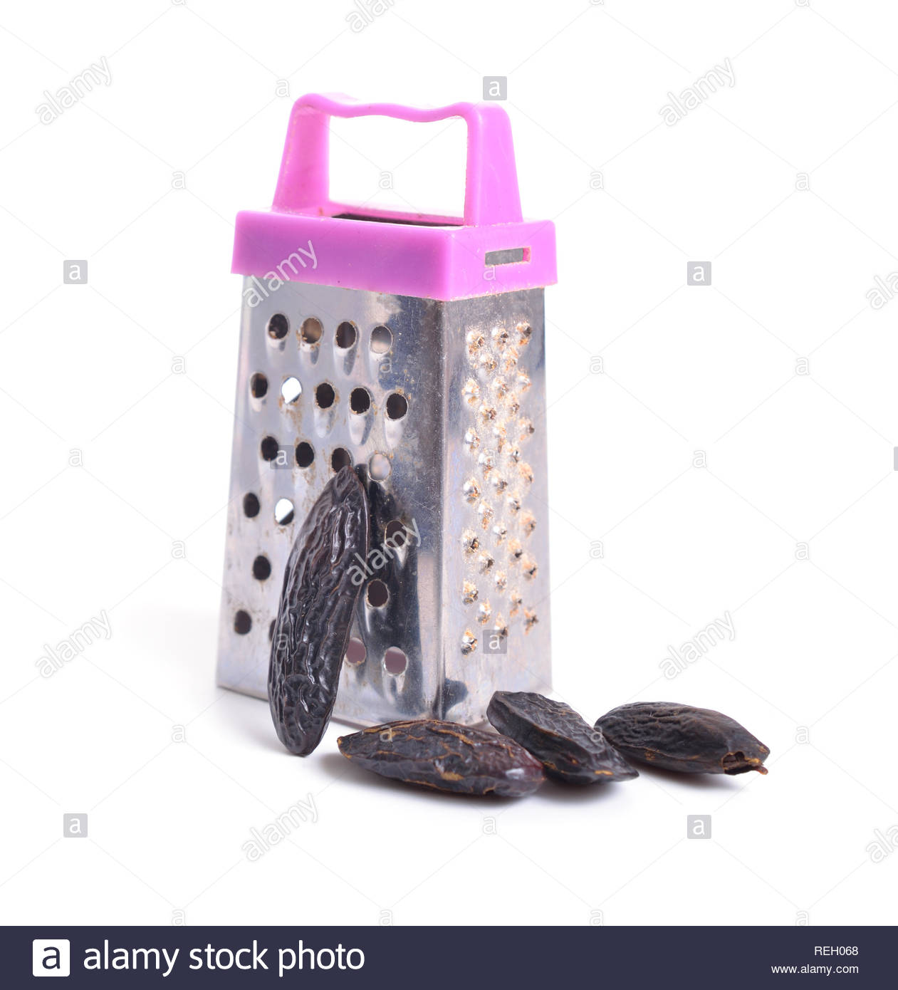Dried Tonka Beans With Little Grater Isolated On White Background