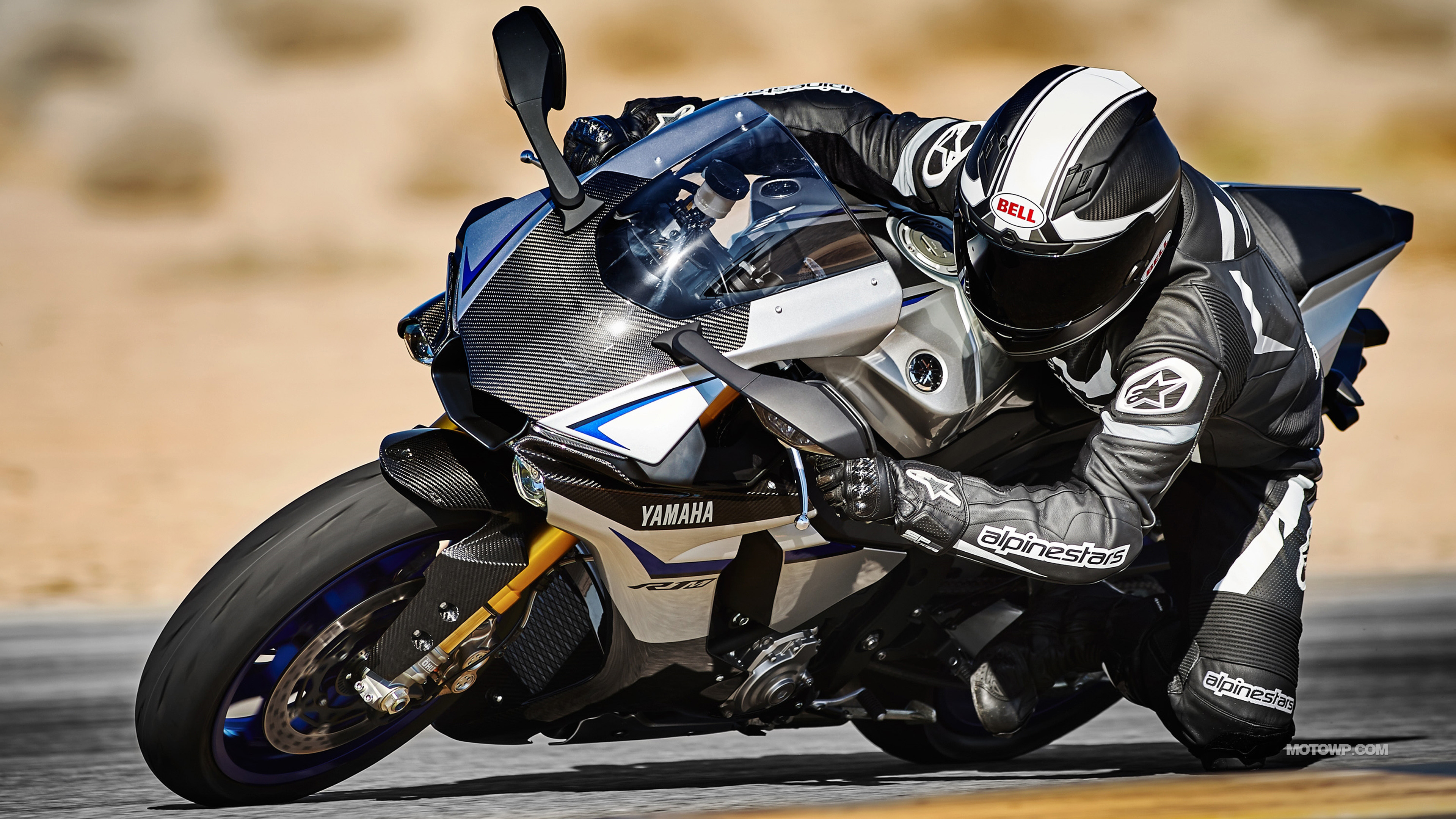 A Yamaha R1 motorcycle leaning into a turn on a racetrack