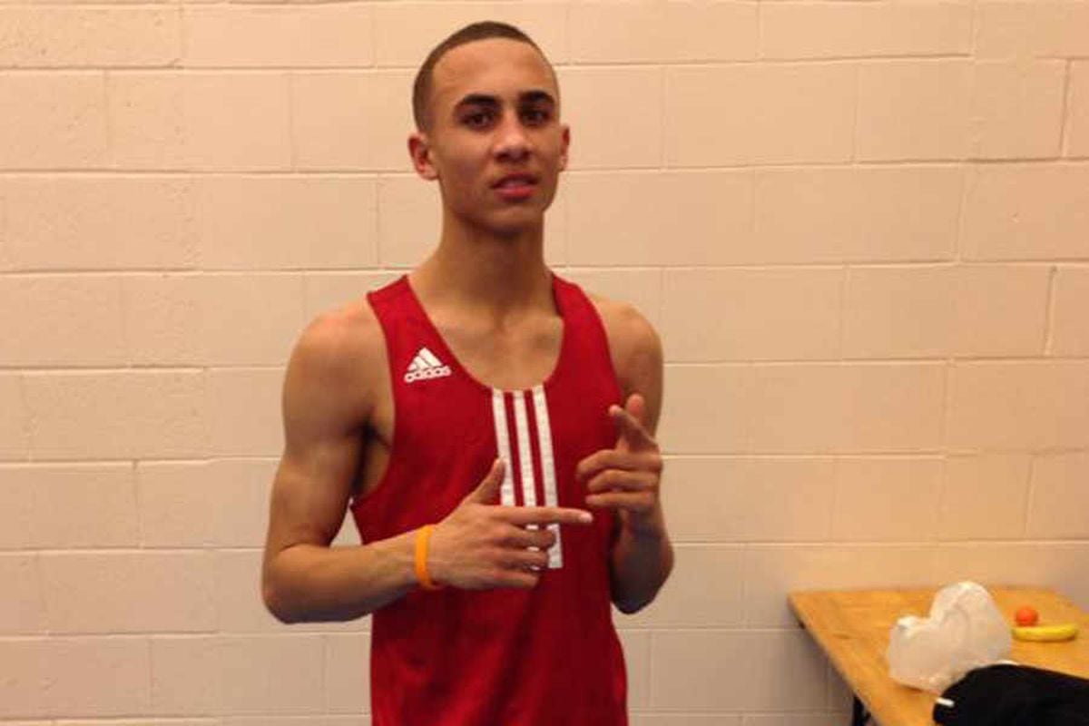 Benjamin Whittaker posing in a red Adidas tank top