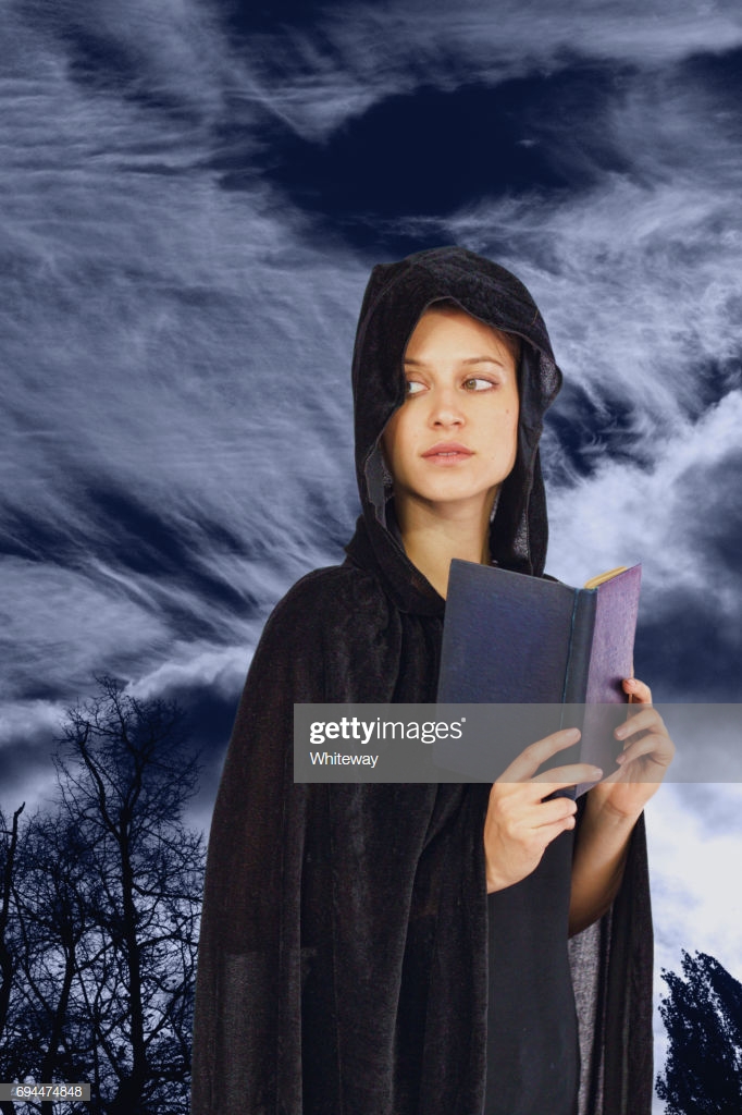 Book Reading Widow Witch In Black Hood Moonlit Background Stock