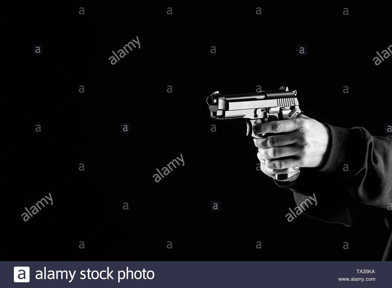 Bandit With Gun On Dark Background Stock Photo