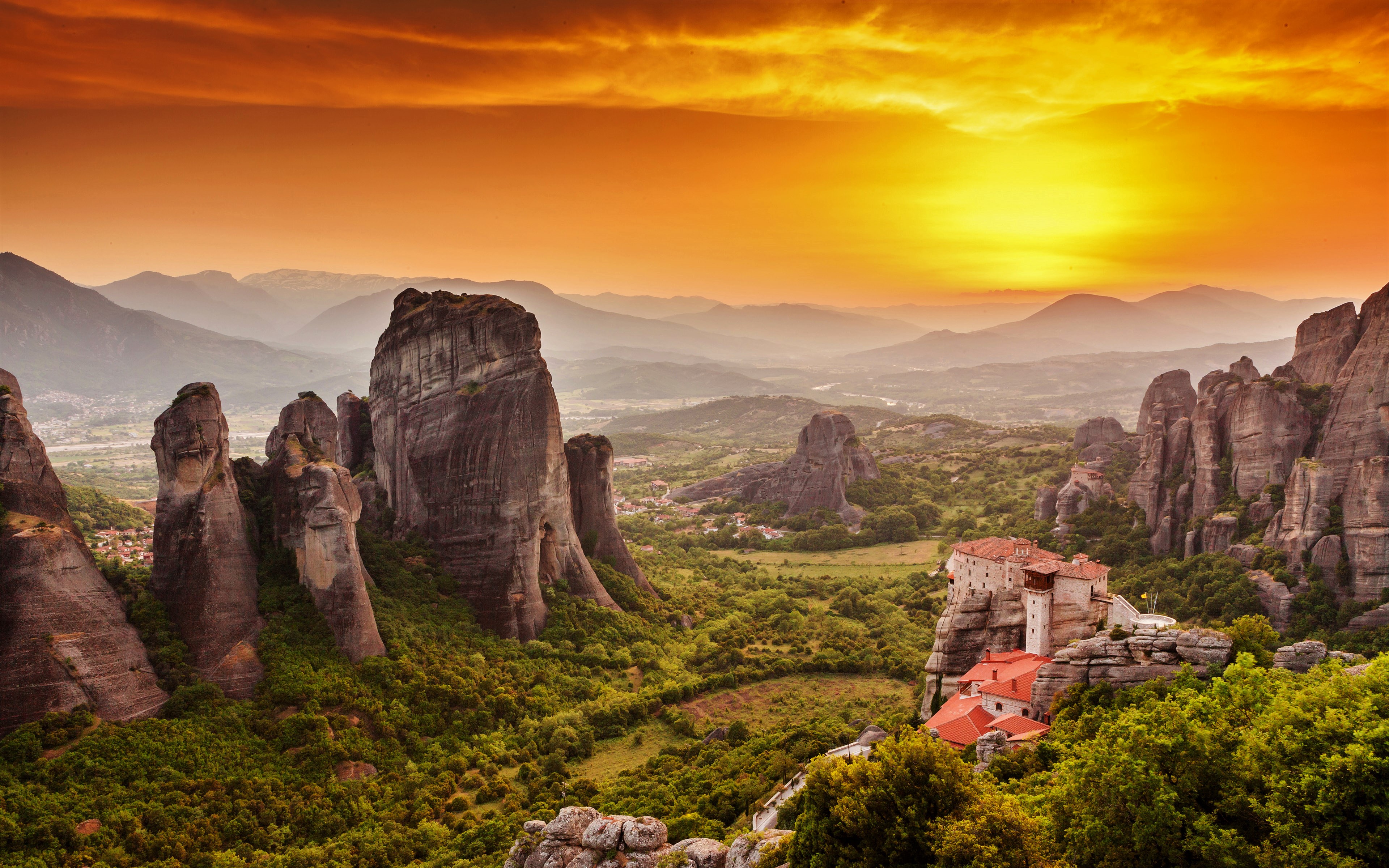 Stunning sunset over the rock formations and monasteries of Meteora, Greece