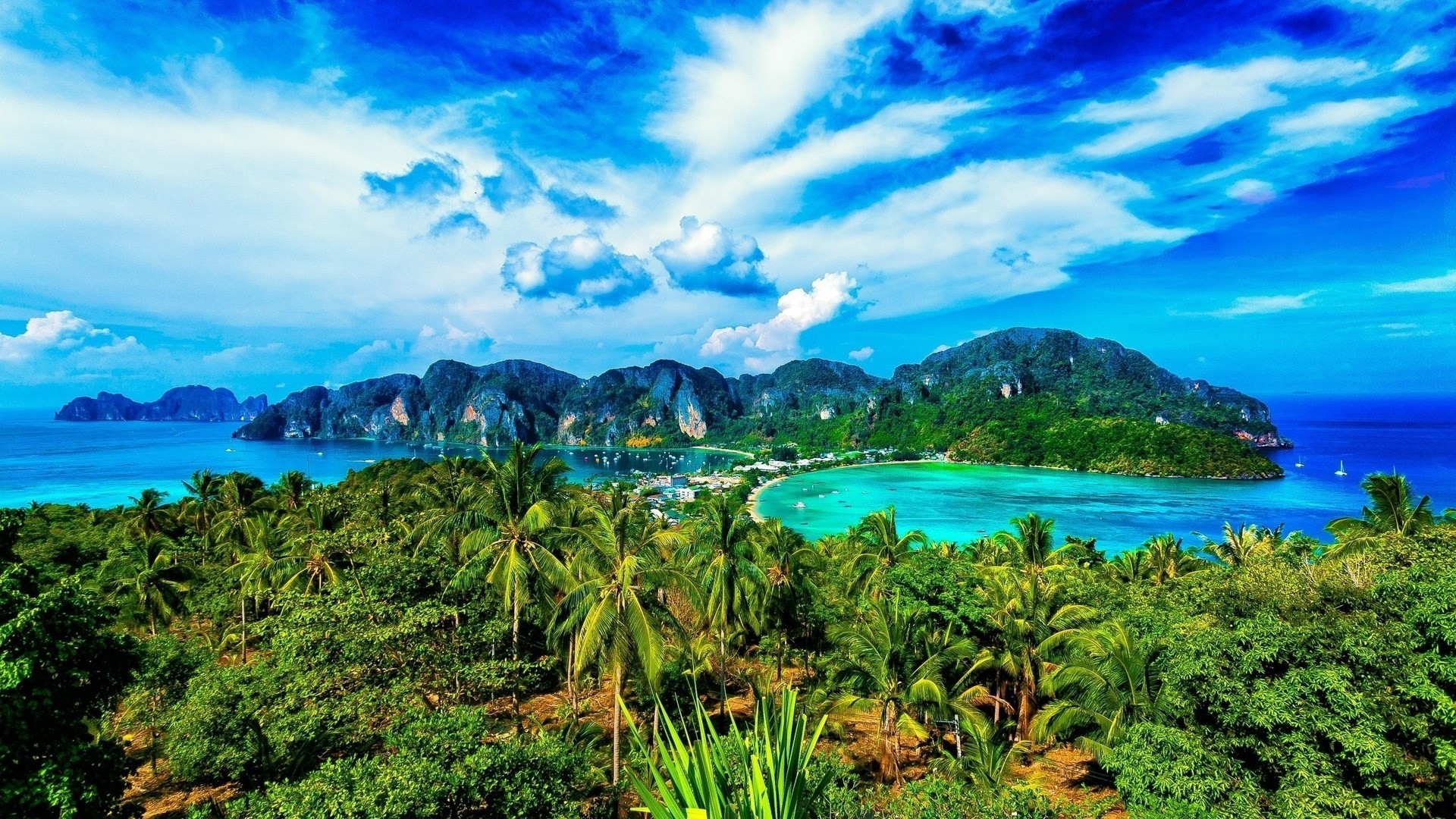 Lush tropical island with turquoise waters and a vibrant blue sky in Thailand