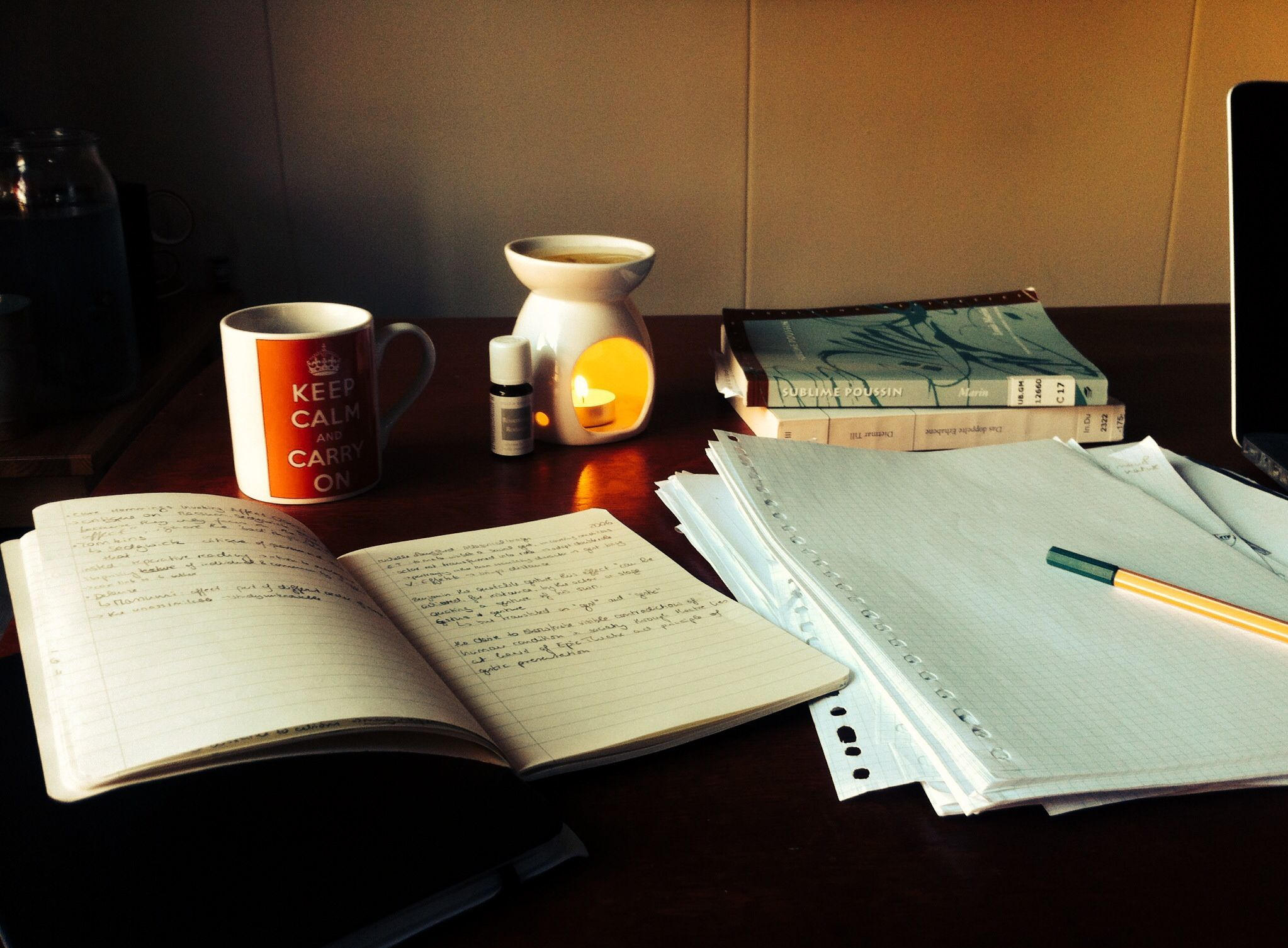 Cozy study space with a Keep Calm mug, oil diffuser, notebooks, and books, perfect for study inspiration