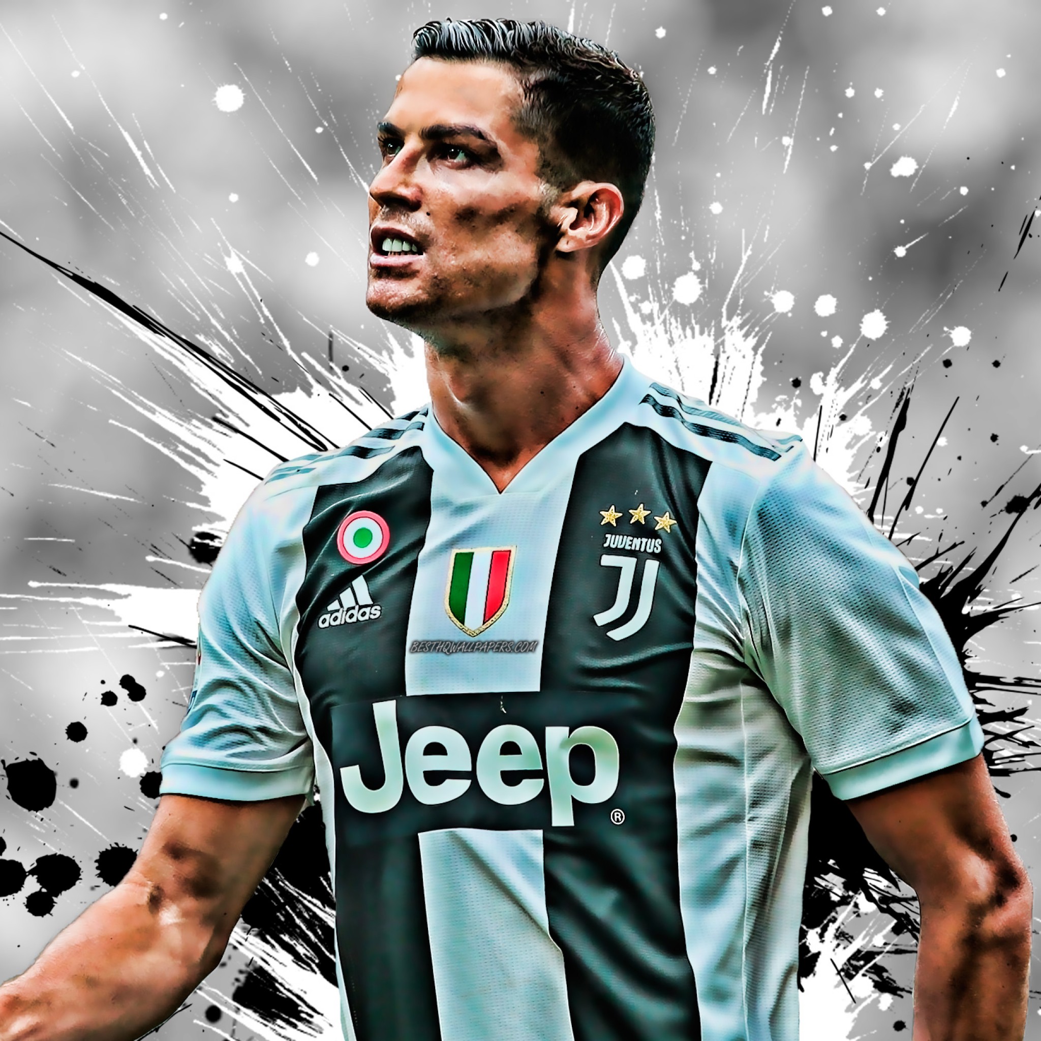 Cristiano Ronaldo in a Juventus jersey, looking upwards with intensity against a dynamic, paint-splattered backdrop