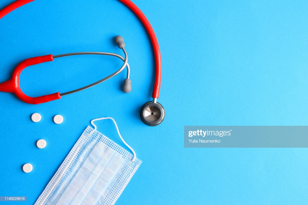 Stethoscope Surgical Mask Pills On A Blue Background Stock Photo
