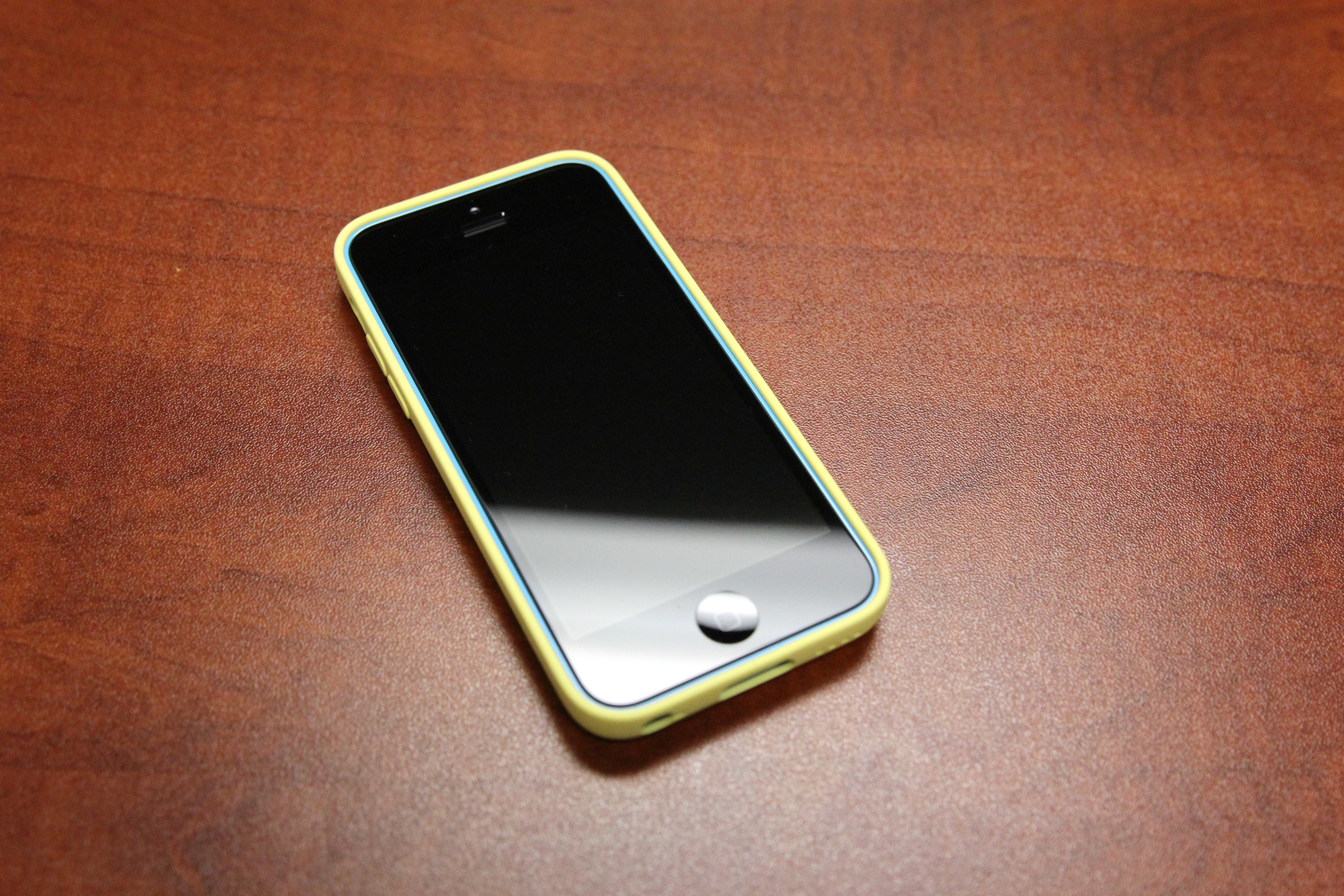 Blue iPhone 5c In Yellow Corporate Cover From Apple Wallpaper And